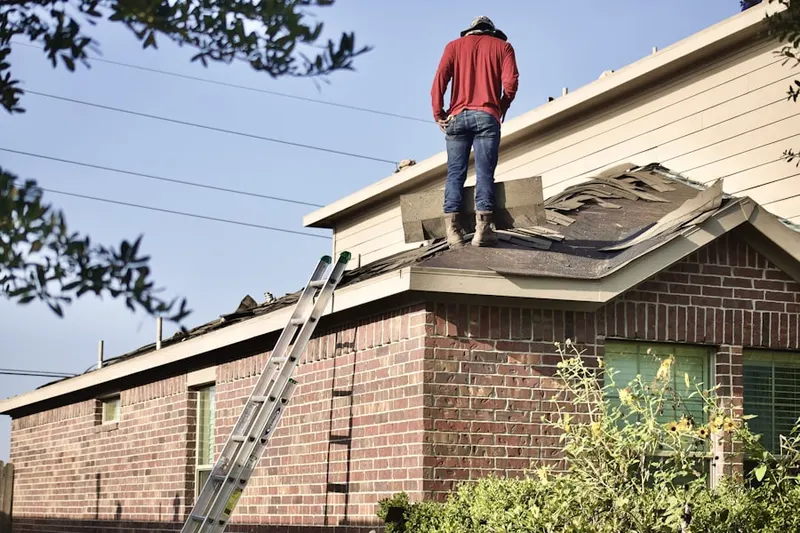 Professional roofer working on a residential roof in Hiestand